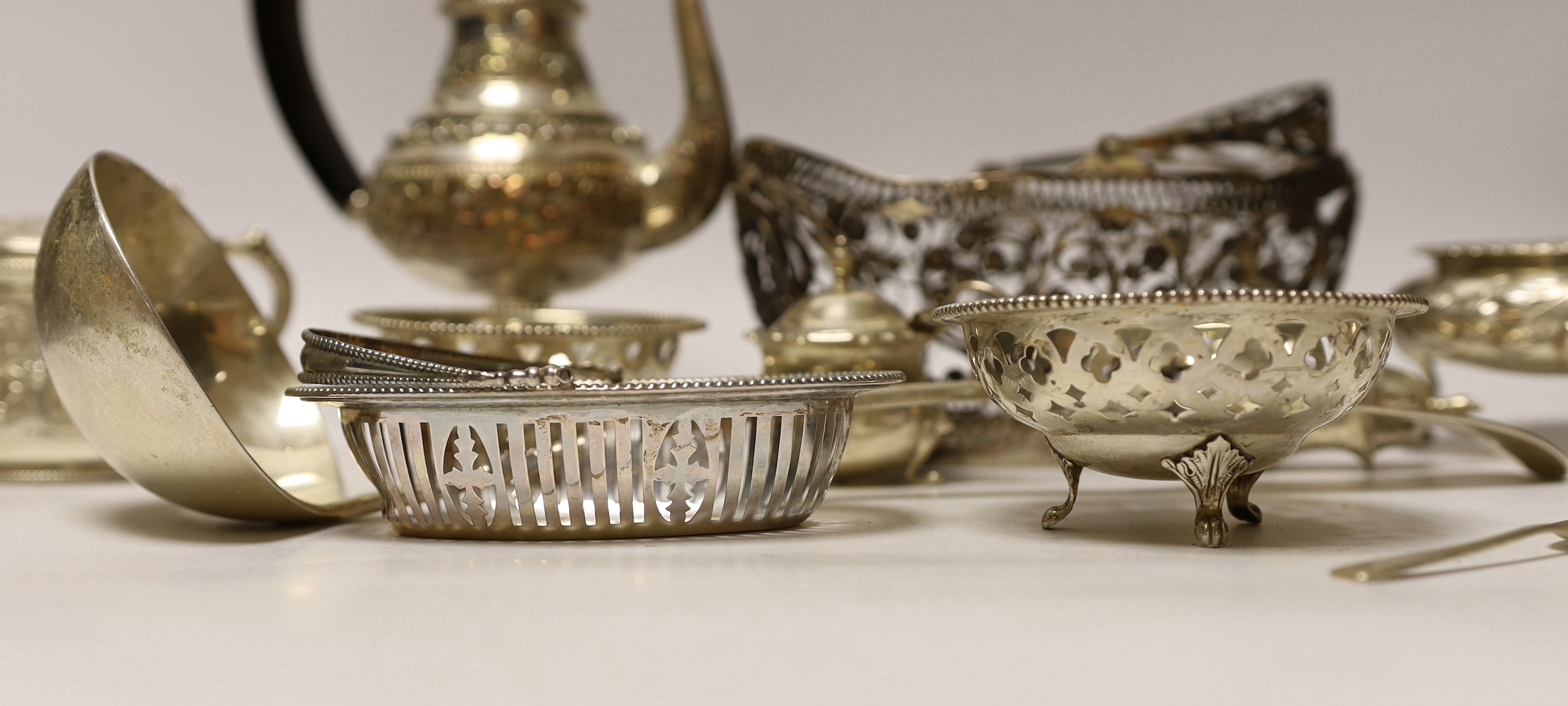 A quantity of silver and white metal items including a continental filigree basket, small silver bonbon dish, George III soup ladle, salts, Victorian silver mustard, etc.